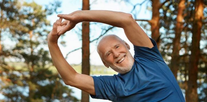 outdoor-shot-of-happy-energetic-senior-retired-man-enjoying-physical-training-in-park-doing-side-bends-exercise-holding-hands-together-with-broad-smile-warming-up-body-before-run1