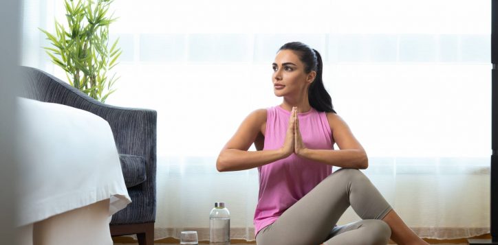 vitality-in-room_woman-doing-yoga-in-guestroom-1