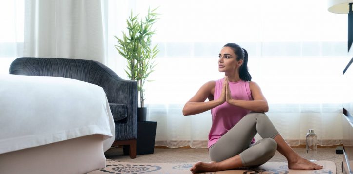 vitality-in-room_woman-doing-yoga-in-guestroom