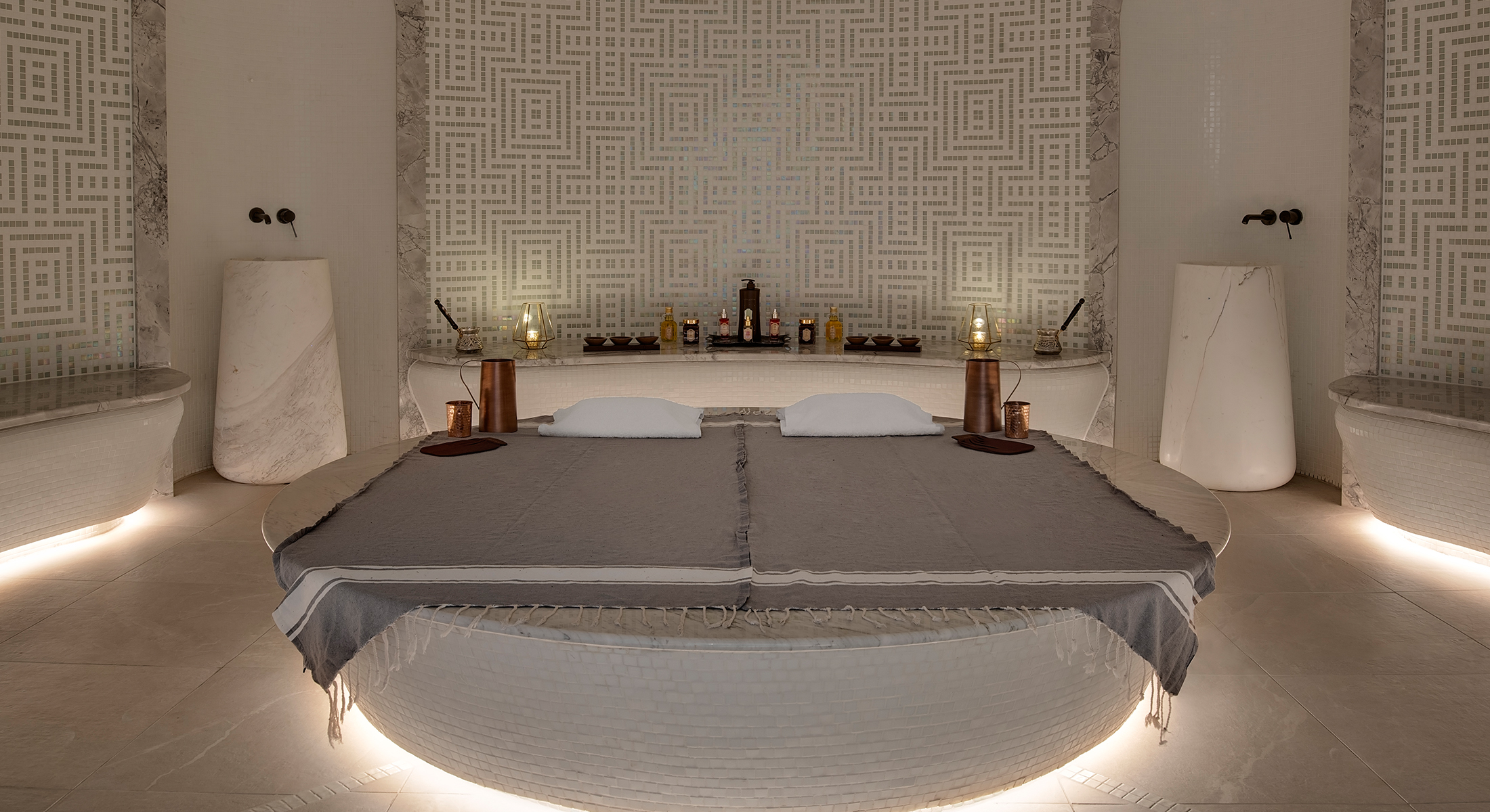 Luxurious Hammam steam room with marble seating and ornate tile design in a five-star spa resort.