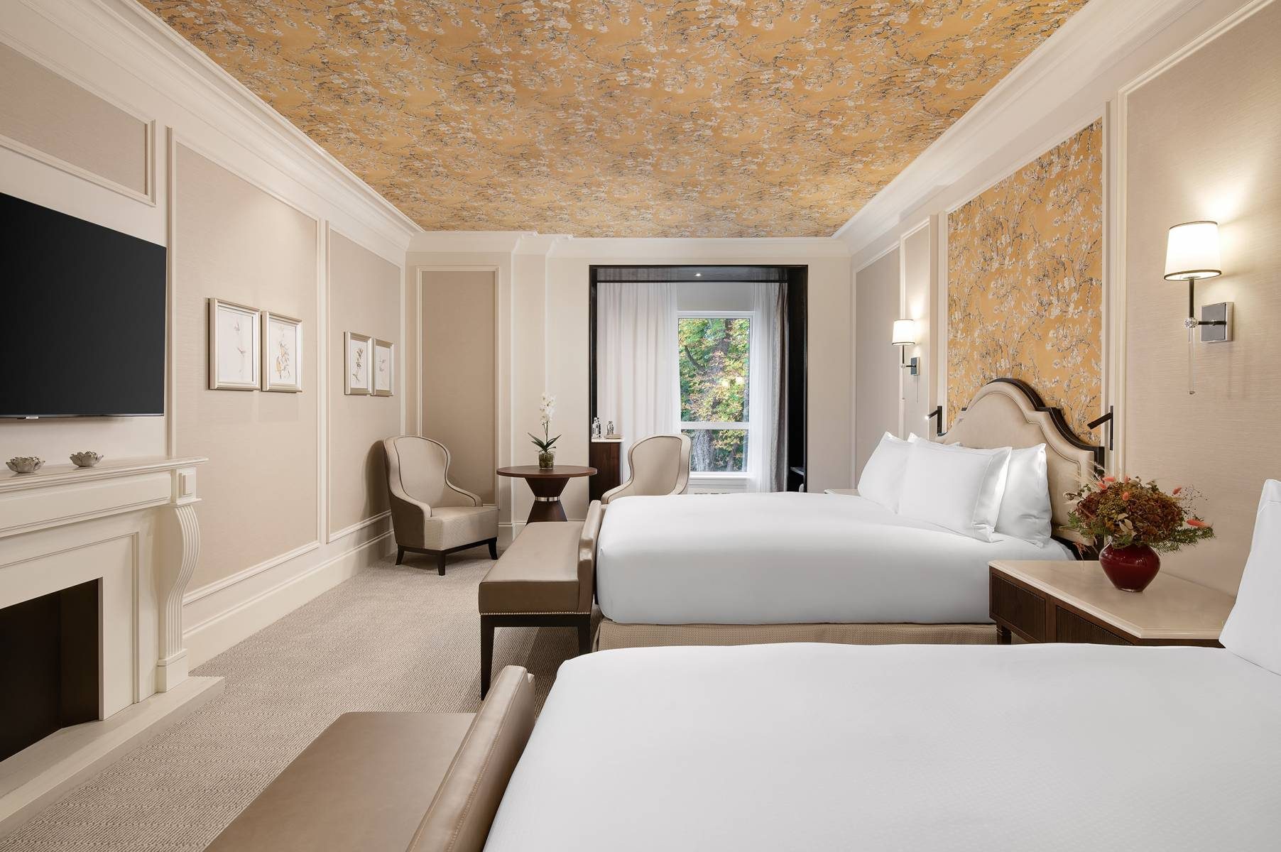 The Double Double room at Fairmont Windsor Park with two large beds, floral decor, and a sitting area by the window.