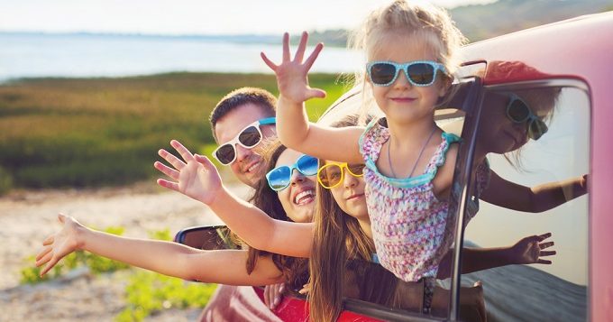 portraitofasmilingfamilywithtwochildrenatbeach