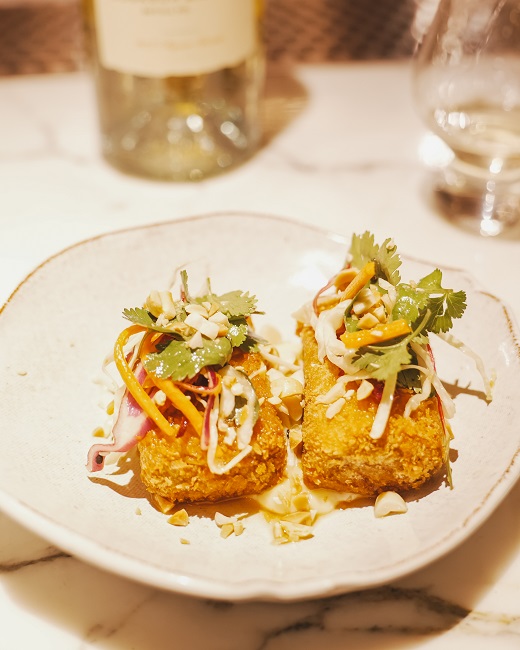 DSC02910 Thai Fish Cakes with peanut sesame slaw – two crispy panko-crumbed fish cakes topped with shredded cabbage, pickled radish, julienned mango, fresh coriander, and chopped peanuts.