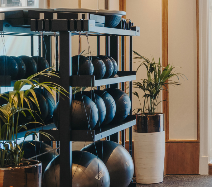 Fairmont Fit fitness studio at Cape Grace featuring exercise balls, resistance equipment, and indoor plants in a bright, contemporary setting.