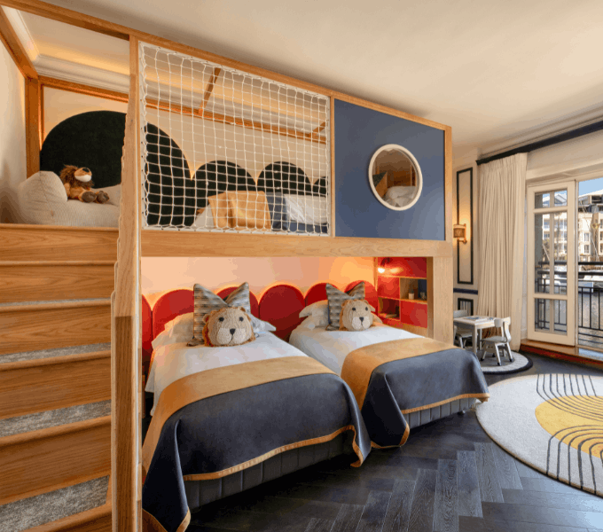 Family suite at Cape Grace featuring bunk beds above twin beds, playful animal-themed décor, and a cosy children’s teepee.