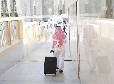 Arabic businessman walking with a suitcase