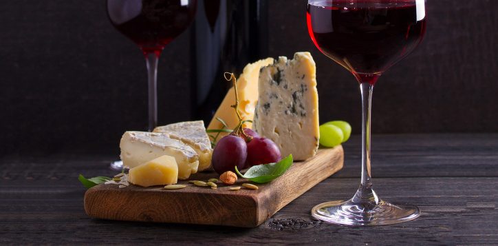 glassandbottleofwinewithcheesegrapesandnuts-3